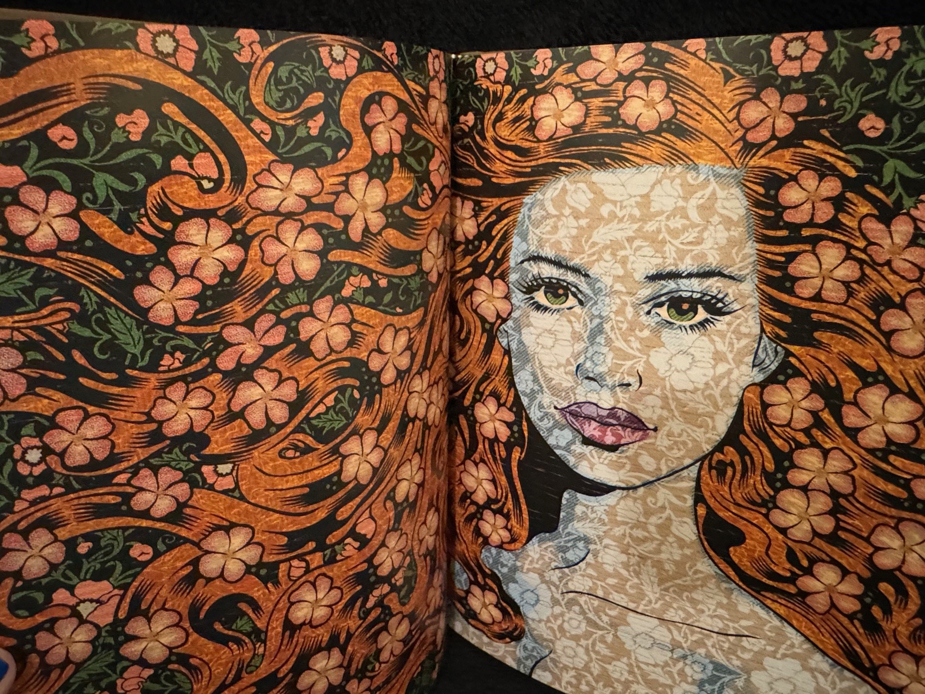 Open art book on heavy matte pages showing a detailed illustration