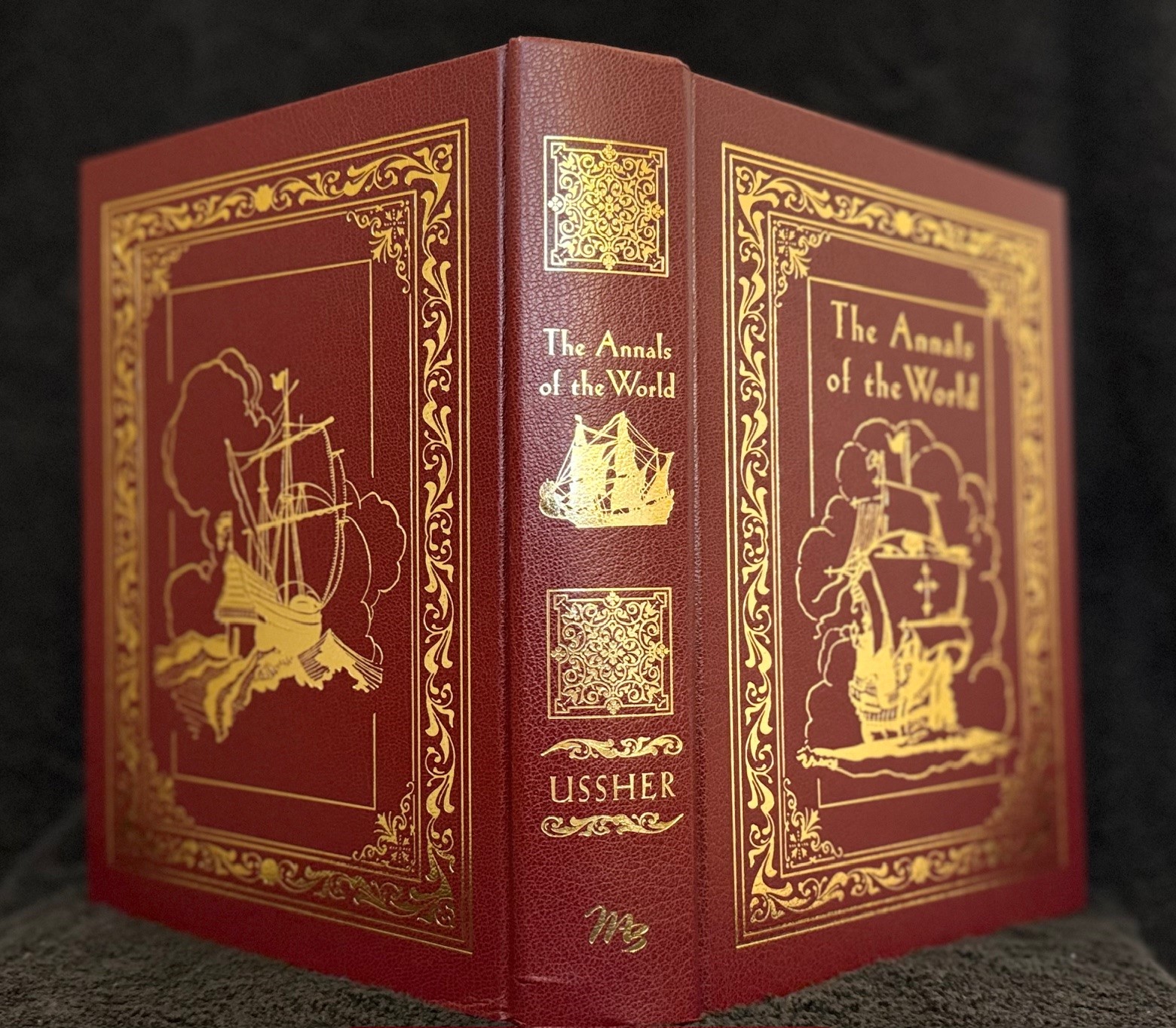 Burgundy leatherette hardcover with detailed gold foil borders and a foil stamped ship