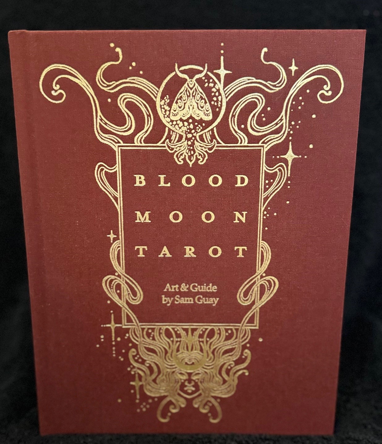 Merlot cloth hardcover with ornate gold foil stamped artwork
